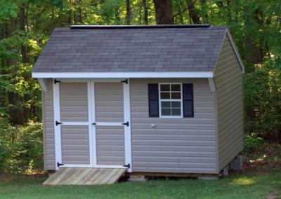 10 x 12 V-Carriage with clay siding, white trim, driftwood shingles, and black shutters