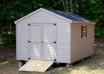 10 x 14 V-A-roof with clay siding and trim, black shingles, and redwood shutters. Wooden Ramp.