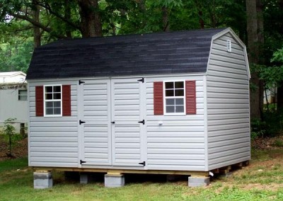 10 x 14 V-High Barn with flint siding and trim, black shingles, and redwood shutters