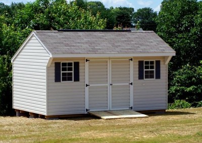 10 x 16 V-Carriage with silvermist siding, white trim, driftwood shingles, and bedford blue shutters