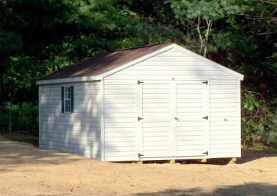 12 x 16 V-A-roof with ivory siding and trim, brownwood shingles and forest green shutters