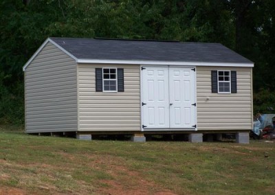 12 x 20 V-A-roof with tan siding , white trim, black shingles and shutters, 6' solid fiber doors
