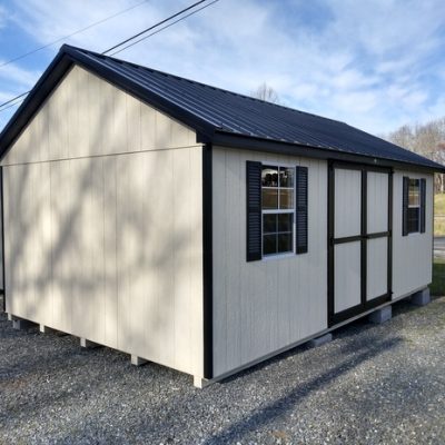 12 x 20 size painted classic style shed with navajo white siding, black trim, black metal roof, black shutters, ggs 6 foot doors, two windows.