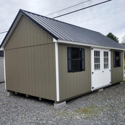 12 x 20 size painted garden style shed with clay siding, white trim, black metal roof, black shutters, fiber 9 lite 6' double shed doors, two black windows.