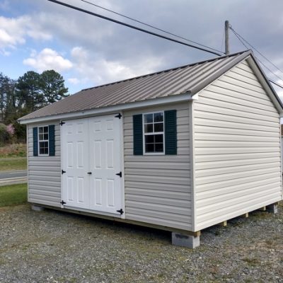 12 x 16 size vinyl classic style shed with mist siding, white trim, burnished slate metal roof, green shutters, fiber 6 foot doors, two windows.